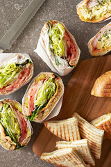 Bagels and sandwiches on cutting board	