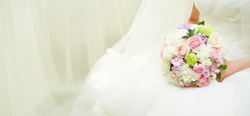 Wedding bouquet in the hands of a bride in a wedding dress	