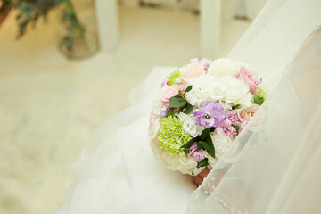 Wedding bouquet in the hands of a bride in a wedding dress	