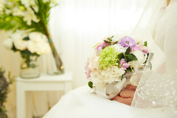 Wedding bouquet in the hands of a bride in a wedding dress	