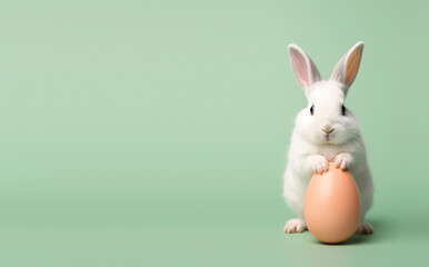 Adorable white Easter bunny holding an egg on a soft pastel green background, festive spring theme.