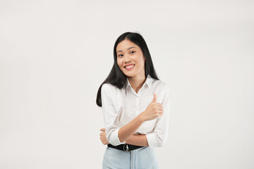 An Asian woman in a white blouse gives a thumbs-up with a cheerful smile. The white background emphasizes her optimism and professionalism in a business setting.