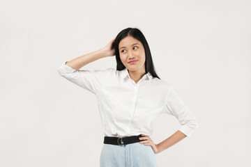 An Asian woman in a white blouse crosses her hands in a determined gesture. She portrays confidence and focus against a plain white background.