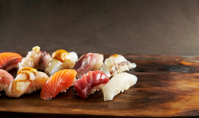 Different types of sushi on wooden plate