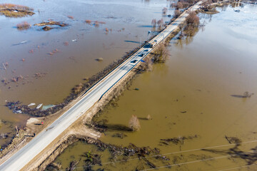 Flight over a highway passing through an area flooded during spring floods