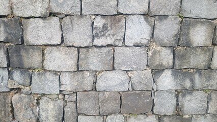 Fototapeta premium Stone wall pattern. Old castle stone wall background. Part of a stone wall, for background or texture. Seamless background texture with different sized stones. Isolated grey stone wall.