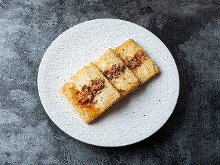 Seasoned grilled tofu on a plate	