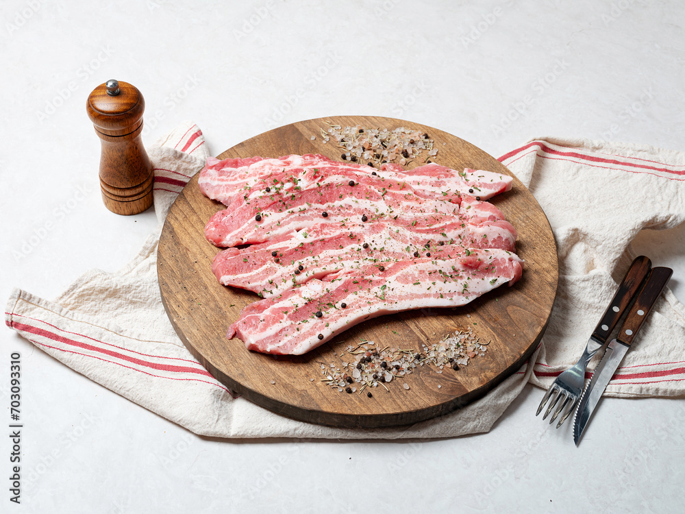 Wall mural Raw meat and spices on wooden board	