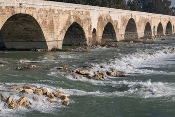 historical stone bridge and seyhan river. taskopru. adana, turkey.