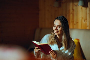 Happy Woman Reading a Book on Vacation Feeling Carefree. Smiling millennial girl checking her...