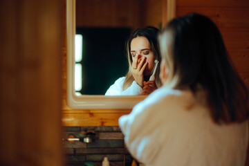 Woman Suffering a Toothache Trying to Brush her Teeth. Unhappy girl feeling in pain from an oral infection and a cavity problem
 - obrazy, fototapety, plakaty
