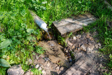 Spring with clean water equipped with a plastic pipe