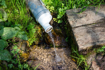 Spring with clean water equipped with a plastic pipe