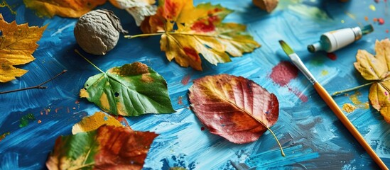 Children's DIY project with step-by-step photo instructions showing finished hand-painted leaves on blue background