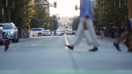Pedestrians and bicycles crossing the busy street in downtown Vancouver. Slow motion. 
