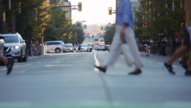 Pedestrians and bicycles crossing the busy street in downtown Vancouver. Slow motion. 