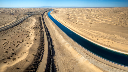 Dramatic aerial view of the all-American canal traveling through the Buttercup sand dunes in...