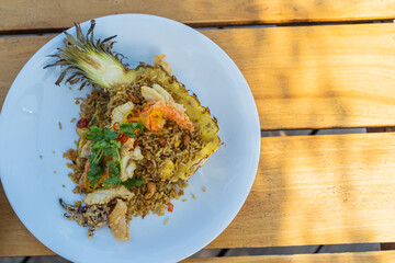 Seafood fried rice in pineapple, appetizing in a cafe next to the sea, Sue Flamingo, Ao Yon Beach, Phuket Thailand