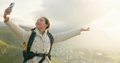 Woman, trekking on mountains and selfie or video call for hiking, adventure and eco friendly blog on social media. Vlogger or influencer with live stream, travel or journey on a hill, rock and nature