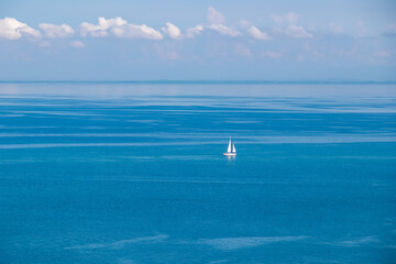 A majestic sailing boat gracefully glides through the crystal clear waters of the Gulf of Piran, located along the captivating Slovenian coastline of the Adriatic Mediterranean Sea. Summer vacation