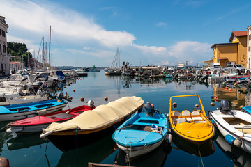 Colorful boats in serene harbor of coastal town Piran, Slovenia, Europe. Tranquil Venetian port in...