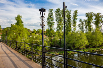 Railing of a metal pedestrian bridge with a decorative lantern. Borovsk, Russia