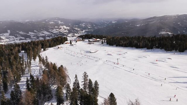 Kreischi poma drag ski lift and slope 4 aerial view towards the valley slow paralax drone shot at Kreischberg ski resort