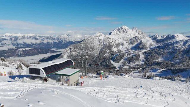 Chairlift Madritschenbahn to ski slope aerial drone shot at Nassfeld Skigebeit ski resort