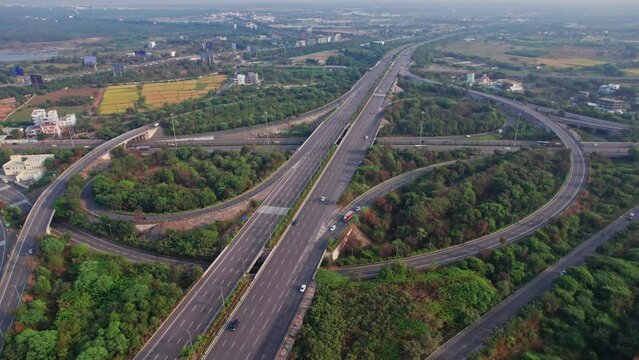 Spectacular Turning Overhead pull back drone Shot of nehru outer ring road Highway showing multiple Roads, Bridges, Viaducts with little car traffic in hyderabad, telangana, india