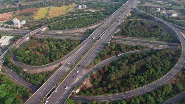 Spectacular Turning Overhead push in drone Shot of nehru outer ring road Highway showing multiple Roads, Bridges, Viaducts with little car traffic in hyderabad, telangana, india