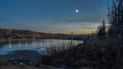 Fort Edmonton footbridge in night lights under dark blue sky