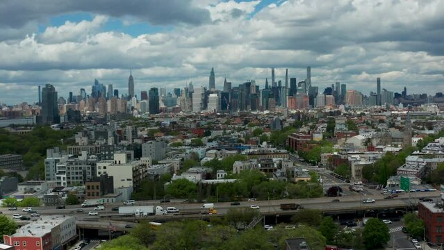Captivating drone push shot revealing Brooklyn's urban charm and the iconic New York City skyline, with a focus on the BQE in the foreground