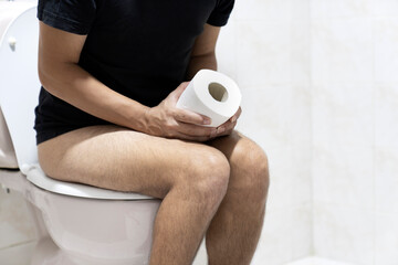 Sitting on toilet with suffering from constipation or hemorrhoid.  Feels uncomfortable in his...