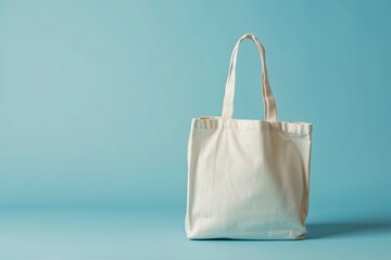 White tote bag without words isolated on light blue background. Mock up