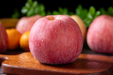  Close up of fresh red apples fruit on table.