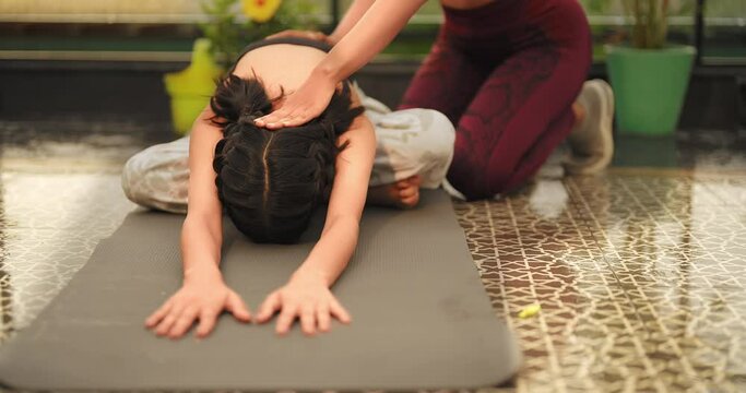 Indian Asian Hindu happy adult woman lady sitting lotus pose on mat do half fold yoga asana class day outdoor home smiling young sports female teach teen girl gym warm up self health care good habit