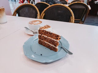 Carrot cake on the table with hot latte for tea time.