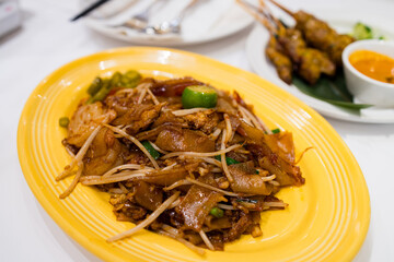 Pan fried flat noodles dish in Thai restaurant