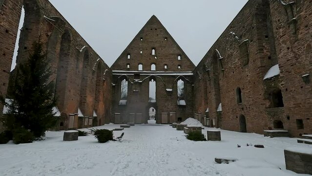 Pirita Convet Ruins in Tallinn Estonia. Historical Architecture of the Pirita Convent. Winter Time Snowy Day. St. Bridget's Convent Ruins Medieval Monastery, Slow Motion Stedycam Shot