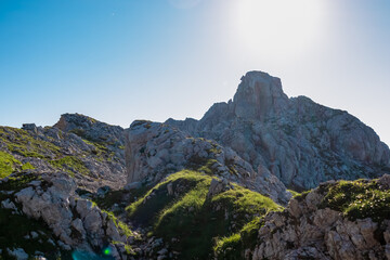 Fototapeta na wymiar Scenic view of majestic mountain summit of Vertatscha (Vrtaca) in untamed Karawanks, border Slovenia Austria. Hiking trail along steep rock cliffs and wilderness of Slovenian Alps in summer
