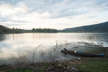 The old thai boat in lake side mountain view