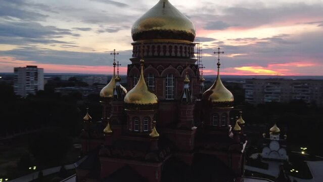 flying over the Church of the Kazan Icon of the Mother of God in Orenburg at a colorful sunset