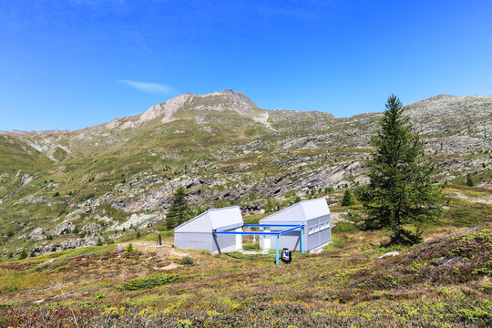 Simplon, Switzerland - August 10.2023: The Simplon Observatory on the Simplon Pass for for astro-amateurs. The blue metal frame will bear the movable roof of the observatory when opening to night sky.