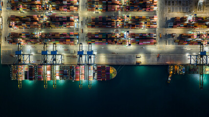 Aerial view container cargo ship at container cargo seaport terminal, Container cargo ship maritime freight shipping global business logistic import export international by container ship at night.