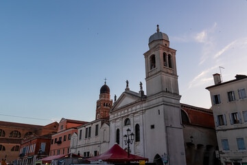 Fototapeta premium Close up view of majestic church Chiesa di San Francesco in old town of Chioggia, Venetian Lagoon, Veneto, Italy. Tranquil sunset atmosphere in summer. Historical landmark with Venetian architecture