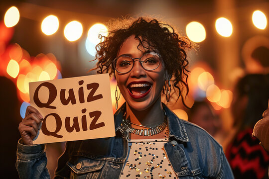 Quiz concept image with happy woman holding a board sign with written word Quiz inside an open space office at work