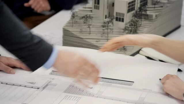 The businessman consulted the design and the terms of real estate purchase agreement.