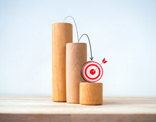 Black down arrows jumping down on 3d target icon on wood blocks, decrease business graph step on white background. Financial crisis, bankruptcy, loss investment economic recession sales risk concepts. - obrazy, fototapety, plakaty