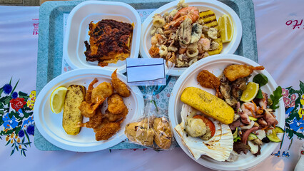 Close up view on a traditional Italian meal with grilled octopus, shrimp, scampi and fish. Delicious fish plate in a restaurant in Chioggia, Italy. Mediterranean seafood cuisine. Sagra del Pesce