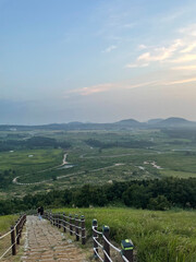 a view of the meadow overlooking the mountain. stairs on the mountain